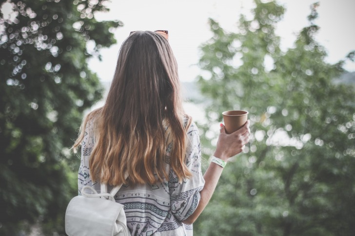 Girl holding coffee cup